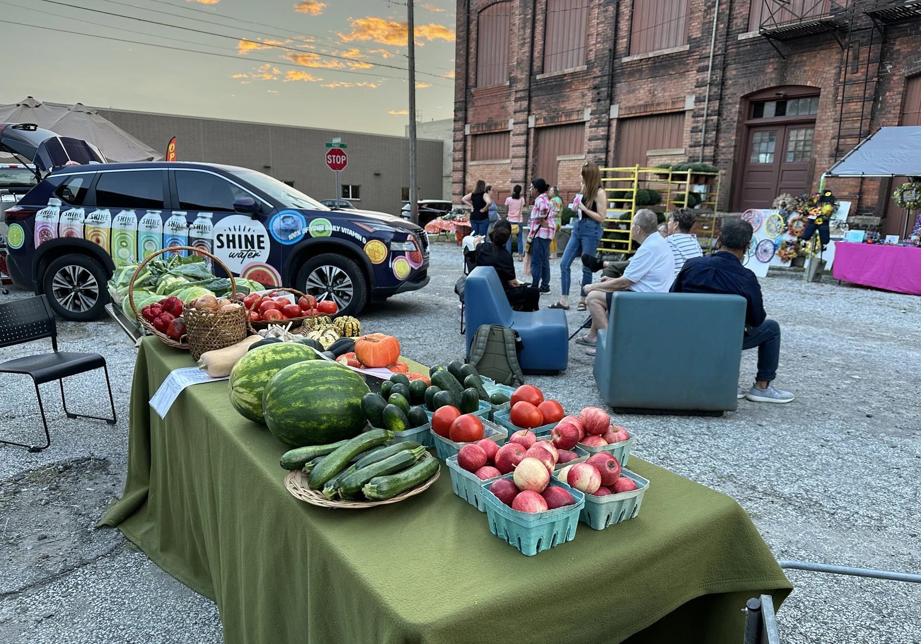 Fresh produce and neighbors at an outdoor community gathering
